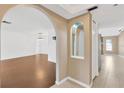 Bright living room featuring sleek wood flooring, arched doorways and neutral paint at 5021 Bridgeport Dr, Safety Harbor, FL 34695
