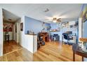 Bright home office featuring hardwood floors, blue walls, and a ceiling fan at 7118 Cherry Laurel Dr, Port Richey, FL 34668
