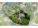 Aerial view of a landscaped property, featuring a home with a pool, surrounded by lush trees at 7268 Crystal Spring Run, Weeki Wachee, FL 34607