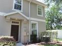 A warm, inviting two-story home featuring a covered entrance and well-kept landscaping at 7650 Red Mill Cir, New Port Richey, FL 34653
