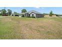 Expansive view of home's exterior with a large lawn, showcasing its curb appeal and location at 8199 Nordica Rd, Weeki Wachee, FL 34613
