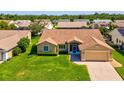 Aerial view of home with lush green lawn in a neighborhood with mature landscaping at 8401 Pavilion Dr, Hudson, FL 34667