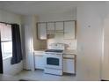 Simple kitchen featuring white appliances, wood cabinets and neutral countertops and flooring at 846 Burlwood St, Brandon, FL 33511