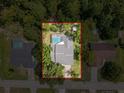 Aerial view of a home with a pool and surrounded by lush greenery, providing privacy and a serene setting at 8979 Hernando Way, Weeki Wachee, FL 34613