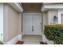 Close-up of the double front doors and an arched entryway at 9149 Penelope Dr, Weeki Wachee, FL 34613