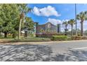 Elegant GlenLakes community sign surrounded by lush landscaping and palm trees at 9406 Burnam Dr, Weeki Wachee, FL 34613