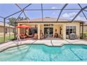 Enclosed pool with an expansive patio, lounge chairs and grilling area at 9406 Burnam Dr, Weeki Wachee, FL 34613