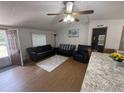 Inviting living room featuring wood-look floors, neutral walls, and a comfortable seating area with an open doorway at 10654 Holgate St, New Port Richey, FL 34654