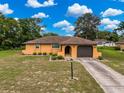 Bright bedroom with a comfortable bed, neutral walls, and ample natural light from the two windows at 11094 Auburndale St, Spring Hill, FL 34609