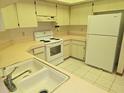 Clean kitchen with white cabinets, countertops, sink, and appliances offering functionality and space at 11263 Murraysville Dr, Spring Hill, FL 34609