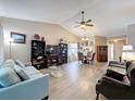 Spacious living area with vaulted ceilings, stylish furnishings, wood flooring, and an open layout at 11622 White Ash Dr, New Port Richey, FL 34654