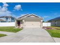 Charming single-story home with a well-maintained lawn and a two-car garage at 12119 Barnsley Reserve Pl, Gibsonton, FL 33534