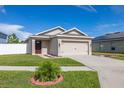 Inviting single-story home with neat landscaping and a spacious driveway at 12119 Barnsley Reserve Pl, Gibsonton, FL 33534