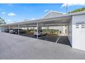 Designated covered parking spaces at 12141 Spartan Way with parked cars and unit numbers displayed at 12141 Spartan Way # 102, Hudson, FL 34667