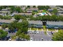 Aerial view of townhome community with pool, playground, and ample parking at 13651 Forest Lake Dr, Largo, FL 33771