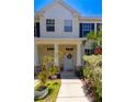 Townhome entrance featuring decorative wreath and stone pillar accents at 13651 Forest Lake Dr, Largo, FL 33771