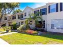 Charming townhome with black shutters and lush landscaping at 13651 Forest Lake Dr, Largo, FL 33771