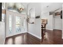 Inviting foyer with decorative glass front door and hardwood floors leading to the dining room at 1478 Brigadier Dr, Spring Hill, FL 34608