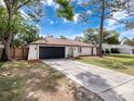 Inviting single-story house with a spacious driveway and tasteful landscaping at 1652 Larkin Rd, Spring Hill, FL 34608