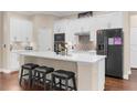 Modern kitchen with a large island, stainless steel appliances, and plenty of cabinet space at 2111 Maximilian Ave, Spring Hill, FL 34609