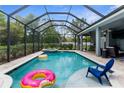 Beautiful screened-in pool with a hot tub and plenty of space for outdoor lounging and entertaining at 2111 Maximilian Ave, Spring Hill, FL 34609