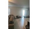 A neutral living room connects to the dining area, showing continuity and modern design with natural light at 22289 Nebula Way, Land O Lakes, FL 34637