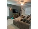 A cozy living room showcases a large sectional, stylish decor, and natural light, creating an inviting atmosphere at 22289 Nebula Way, Land O Lakes, FL 34637