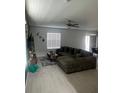 Comfortable living room features a large sectional couch, neutral tile flooring, and natural light through the windows at 22289 Nebula Way, Land O Lakes, FL 34637