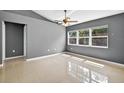 Sunlit bedroom with tile flooring, gray paint, and a large window offering natural light at 2476 Magellan Ave, Spring Hill, FL 34608