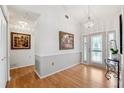 Inviting foyer with beautiful hardwood floors, decorative lighting, and an elegant front door at 3204 Payne St, New Port Richey, FL 34655