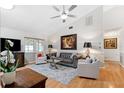 Bright living room featuring a vaulted ceiling, hardwood floors, and tastefully appointed furnishings at 3204 Payne St, New Port Richey, FL 34655