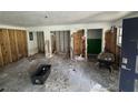 Demolished living room with exposed studs and significant debris on the floor at 34767 Evergreen Way, Ridge Manor, FL 33523