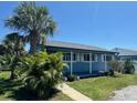 A bright blue single-story home with lush front lawn and a mature palm tree at 4027 31St N Ave, St Petersburg, FL 33713