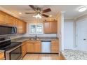 Bright kitchen with stainless steel appliances, stone countertops, and wood cabinets at 4452 Garnet Dr # 302, New Port Richey, FL 34652