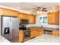 Well-lit kitchen features stainless steel appliances, granite counters, and ample cabinet space at 4452 Garnet Dr # 302, New Port Richey, FL 34652