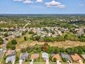 Aerial view showcases a neighborhood with mature trees and well-maintained yards at 489 Tournament Dr, Spring Hill, FL 34608