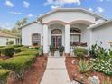Welcoming front entrance with colorful plants and manicured landscaping at 489 Tournament Dr, Spring Hill, FL 34608