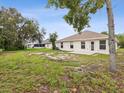 A spacious backyard featuring a grassy area, perfect for outdoor activities and relaxation at 5048 Teather St, Spring Hill, FL 34608