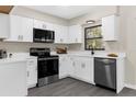Modern kitchen featuring stainless steel appliances, and white cabinets at 5215 Azalea Cir, Dade City, FL 33523