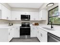 Modern kitchen with white cabinets, quartz countertops, and stainless steel appliances at 5215 Azalea Cir, Dade City, FL 33523