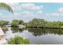 Picturesque water views from the condominium's exterior, surrounded by lush trees and landscaping at 5640 Ferguson Ct # 2203, New Port Richey, FL 34652