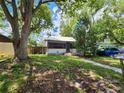 Charming single-story home with lush landscaping, and a cozy screened porch at 5748 Montana Ave, New Port Richey, FL 34652