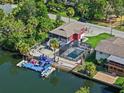 Beautiful aerial view of waterfront home, showcasing its pool, private dock and access to the channel at 6241 Colony Cir, Weeki Wachee, FL 34607