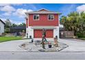 Charming two-story home with a well-manicured front yard and a unique circular driveway, offering curb appeal at 6241 Colony Cir, Weeki Wachee, FL 34607