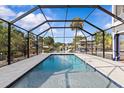 Inviting enclosed pool area, perfect for relaxing and enjoying the outdoors in a private setting at 6241 Colony Cir, Weeki Wachee, FL 34607