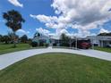 Inviting single-Gathering home with a long driveway, lush lawn, and tropical trees, perfect for a relaxed Florida lifestyle at 6737 Clark St, Hudson, FL 34667