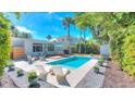 Inviting backyard pool area with a patio, lounge chairs, and lush landscaping for ultimate relaxation at 750 Lantana Ave, Clearwater, FL 33767