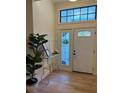 Welcoming entryway with decorative front door, modern console table, and a beautiful fiddle-leaf fig plant at 8209 Golf Club Ct, Hudson, FL 34667