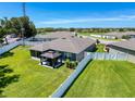 Large backyard features a manicured lawn, gazebo, and a white vinyl fence at 8855 Prairie Creek Dr, New Port Richey, FL 34655