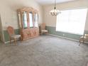 Inviting dining area with natural light and classic china cabinet providing ample space for storage at 9168 Southern Comfort Ct, Weeki Wachee, FL 34613